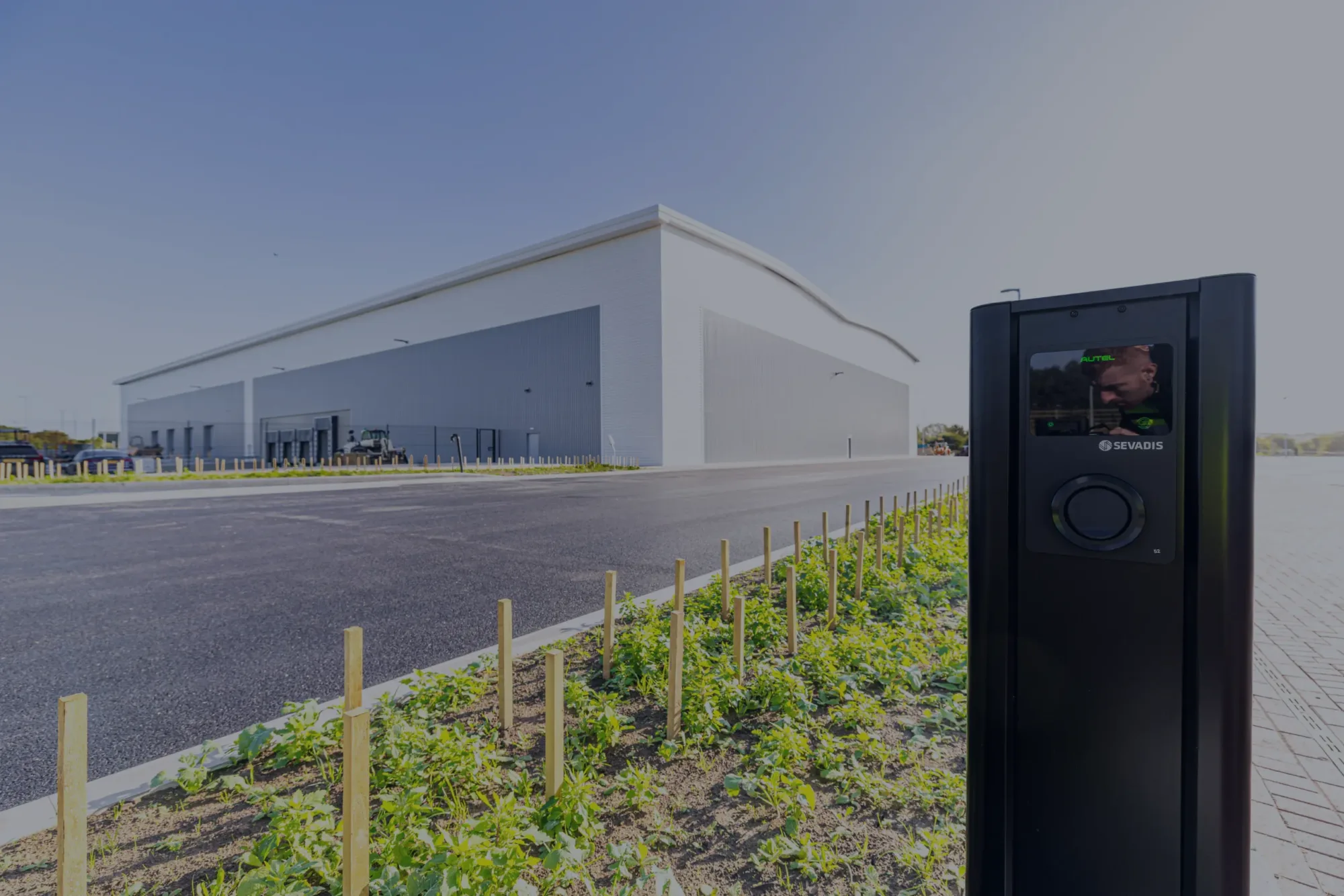 Ground-level shot of Panattoni Park Rotherham 80 unit in the background, with EV charging point in the foreground